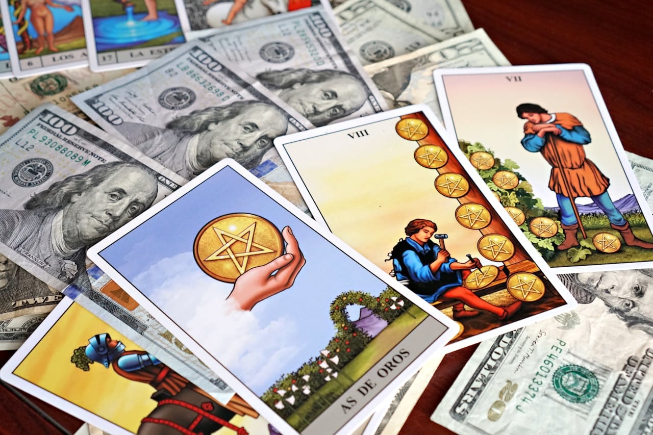 Tarot cards placed on US dollar bills, symbolizing wealth, fortune, and financial divination.